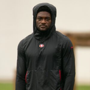 San Francisco 49ers wide receiver Brandon Aiyuk (in black hoodie) watches his teammates work out during the second day of training camp.