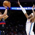 Detroit Pistons guard Cade Cunningham (2) shoots on Oklahoma City Thunder guard Shai Gilgeous-Alexander (2) in the first half at Little Caesars Arena.