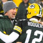 Green Bay Packers former quarterback Brett Favre hugs Green Bay Packers quarterback Aaron Rodgers (12) at half time for a NFL game against the Chicago Bears on Thanksgiving at Lambeau Field.