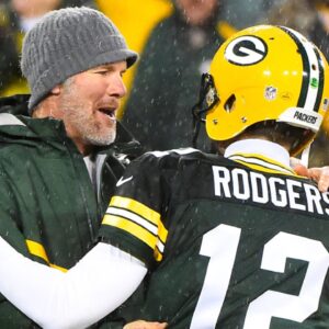 Green Bay Packers former quarterback Brett Favre hugs Green Bay Packers quarterback Aaron Rodgers (12) at half time for a NFL game against the Chicago Bears on Thanksgiving at Lambeau Field.