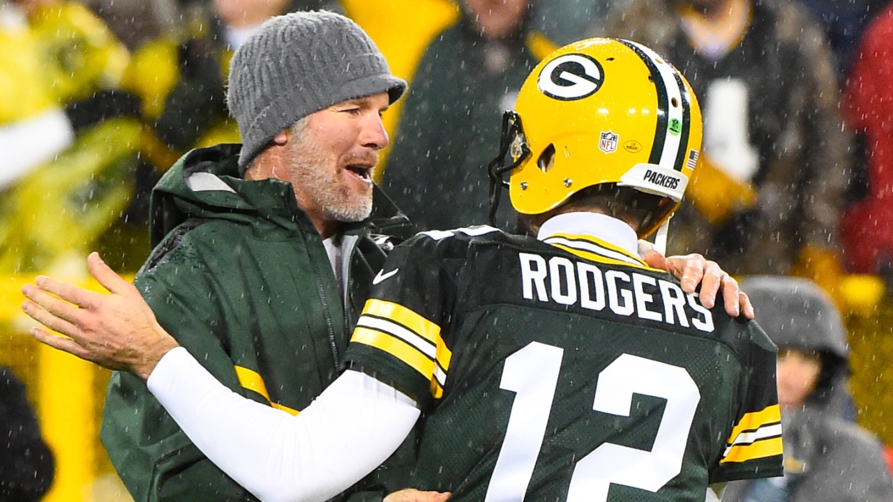 Green Bay Packers former quarterback Brett Favre hugs Green Bay Packers quarterback Aaron Rodgers (12) at half time for a NFL game against the Chicago Bears on Thanksgiving at Lambeau Field.