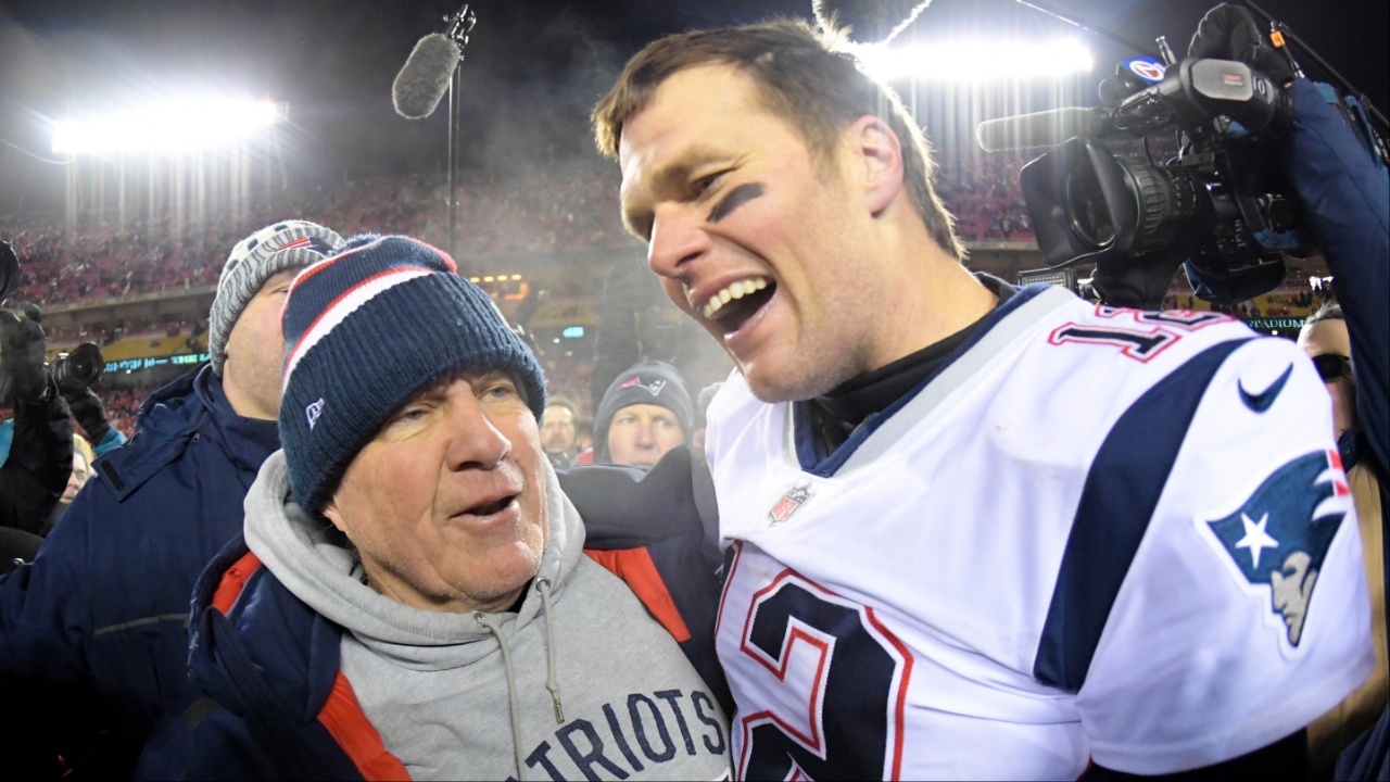 New England Patriots head coach Bill Belichick and quarterback Tom Brady (12) celebrate the win over the Kansas City Chiefs during overtime in the AFC Championship game at Arrowhead Stadium.