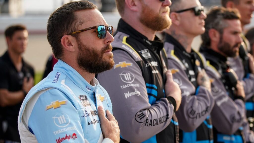 NASCAR Cup Series driver Ross Chastain stands with his team during the national anthem before the Cracker Barrel 400 at Nashville Superspeedway in Lebanon, Tenn., Sunday, June 1, 2025.