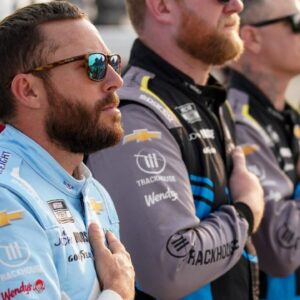 NASCAR Cup Series driver Ross Chastain stands with his team during the national anthem before the Cracker Barrel 400 at Nashville Superspeedway in Lebanon, Tenn., Sunday, June 1, 2025.