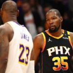 Phoenix Suns forward Kevin Durant (35) looks at Los Angeles Lakers forward LeBron James (23) during the third quarter at Footprint Center.