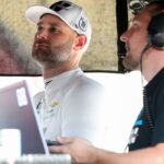 NASCAR Cup Series driver Shane Van Gisbergen (left) looks at a computer monitor on pit road during practice and qualifying for the Go Bowling at The Glen at Watkins Glen International.