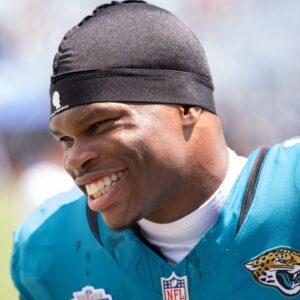 Jacksonville Jaguars wide receiver Travis Hunter (12) has a laugh while warming up before the start of an NFL football game between the Carolina Panthers at Jacksonville Jaguars at EverBank Stadium Sunday September 7, 2025. [Doug Engle/Florida Times-Union]