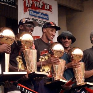 Jun 16, 1997; Chicago, IL, USA; Chicago Bulls players, left to right, Ron Harper, Dennis Rodman, Scottie Pippen, Michael Jordan & coach Phil Jackson hold up the Bulls' five championship trophies at a rally in Grant Park. Mandatory Credit: Anne Ryan-USA TODAY