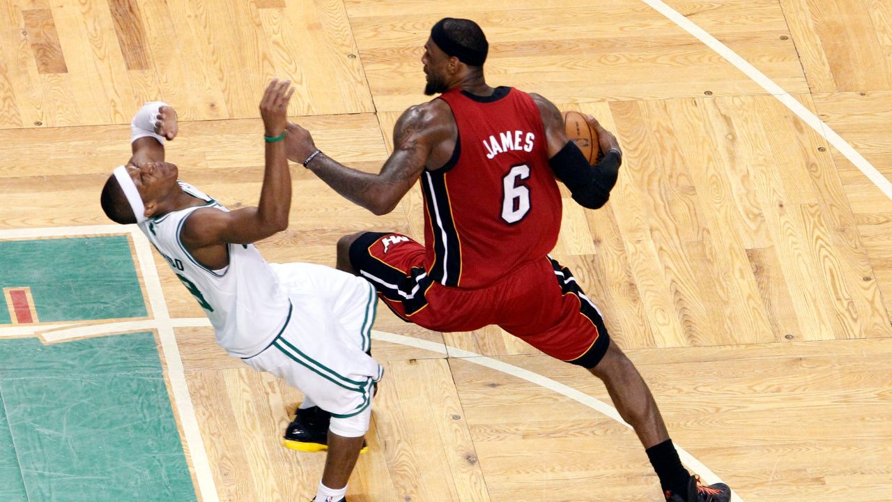 Boston Celtics point guard Rajon Rondo (9) fouls Miami Heat small forward LeBron James (6) during the second half in game six of the Eastern Conference finals of the 2012 NBA playoffs at TD Garden.