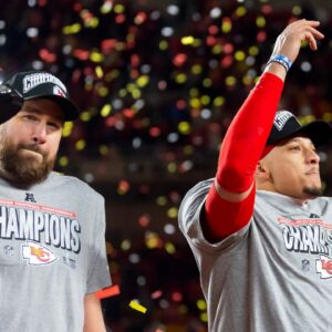 Confetti falls as Kansas City Chiefs tight end Travis Kelce (left) celebrates with the Lamar Hunt Trophy with quarterback Patrick Mahomes after defeating the Buffalo Bills during the AFC Championship game at GEHA Field at Arrowhead Stadium.