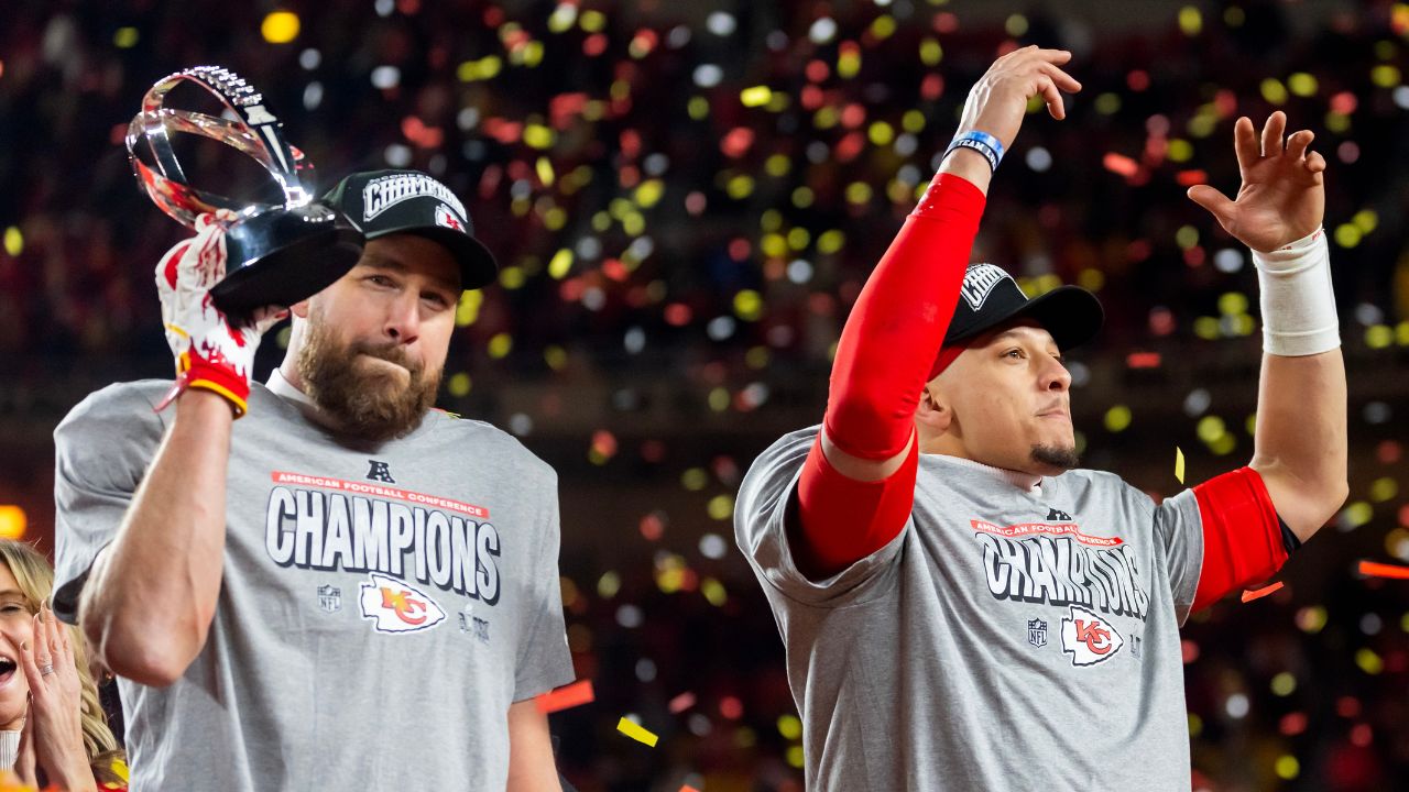 Confetti falls as Kansas City Chiefs tight end Travis Kelce (left) celebrates with the Lamar Hunt Trophy with quarterback Patrick Mahomes after defeating the Buffalo Bills during the AFC Championship game at GEHA Field at Arrowhead Stadium.