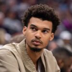 Mar 7, 2025; Sacramento, California, USA; San Antonio Spurs center Victor Wembanyama (1) looks on from the bench during the fourth quarter of the game against the Sacramento Kings at Golden 1 Center.