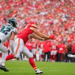 Philadelphia Eagles safety Andrew Mukuba (24) intercepts a pass intended for Kansas City Chiefs tight end Travis Kelce (87) during the fourth quarter of the game at GEHA Field at Arrowhead Stadium.