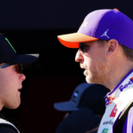 Feb 19, 2024; Daytona Beach, Florida, USA; NASCAR Cup Series driver Denny Hamlin (11) and driver Ty Gibbs (54) talk during driver introductions before the Daytona 500 at Daytona International Speedway. Mandatory Credit: John David Mercer-Imagn Images