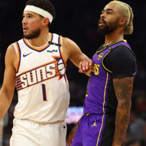 Oct 28, 2024; Phoenix, Arizona, USA; Los Angeles Lakers guard D'Angelo Russell (right) against Phoenix Suns guard Devin Booker at Footprint Center.