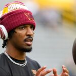 Washington Commanders quarterback Jayden Daniels (5) warms up before a game against the Green Bay Packers at Lambeau Field.