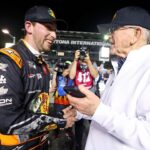 NASCAR Cup Series driver Chase Briscoe (19) celebrates with team owner Joe Gibbs after winning the pole during qualifying for the Daytona 500 at Daytona International Speedway.