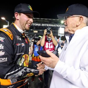 NASCAR Cup Series driver Chase Briscoe (19) celebrates with team owner Joe Gibbs after winning the pole during qualifying for the Daytona 500 at Daytona International Speedway.
