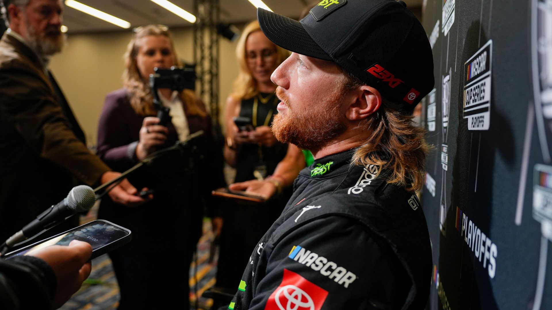 Aug 27, 2025; Charlotte, NC, USA; Tyler Reddick answers questions from the media during NASCAR Cup Series Playoff Media Day at Charlotte Convention Center