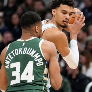 Jan 8, 2025; Milwaukee, Wisconsin, USA; San Antonio Spurs forward Victor Wembanyama (1) holds the ball away from Milwaukee Bucks forward Giannis Antetokounmpo (34) during the second quarter at Fiserv Forum.