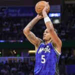 Mar 30, 2024; Orlando, Florida, USA; Orlando Magic forward Paolo Banchero (5) shoots a three point basket during the second quarter against the Memphis Grizzlies at KIA Center.