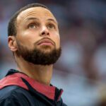 Golden State Warriors guard Stephen Curry (30) looks on from the bench against the Minnesota Timberwolves in the second half during game two of the second round for the 2025 NBA Playoffs at Target Center