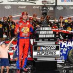 NASCAR Cup Series driver Chase Briscoe (19) celebrates his win with his son Brooks at the Cook Out Southern 500 at Darlington Raceway.