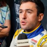 Aug 27, 2025; Charlotte, NC, USA; Chase Elliott answers questions from the media during NASCAR Cup Series Playoff Media Day at Charlotte Convention Center.