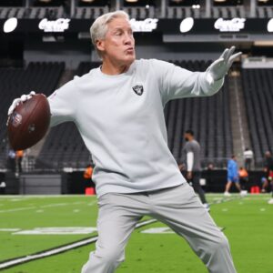 Las Vegas Raiders head coach Pete Carroll throws a ball before the game against the Los Angeles Chargers at Allegiant Stadium.