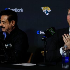 New Jacksonville Jaguars head coach Liam Coen, right, claps next to Jaguars owner Shad Khan after speaking and being introduced during a press conference.