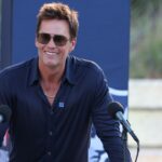 Retired New England Patriot Hall of Famer Tom Brady speaks during a statue unveiling before a game against the Washington Commanders at Gillette Stadium.
