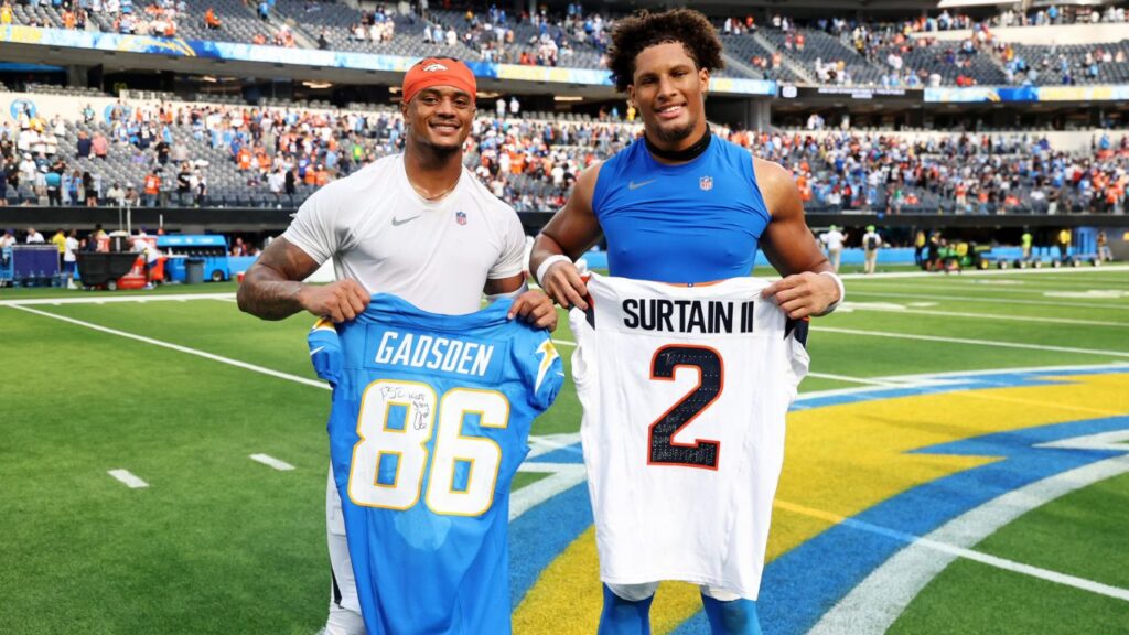 Denver Broncos cornerback Pat Surtain II (2) and Los Angeles Chargers tight end Oronde Gadsden II (86) trade jerseys after the game at SoFi Stadium.