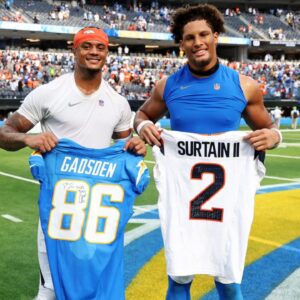 Denver Broncos cornerback Pat Surtain II (2) and Los Angeles Chargers tight end Oronde Gadsden II (86) trade jerseys after the game at SoFi Stadium.