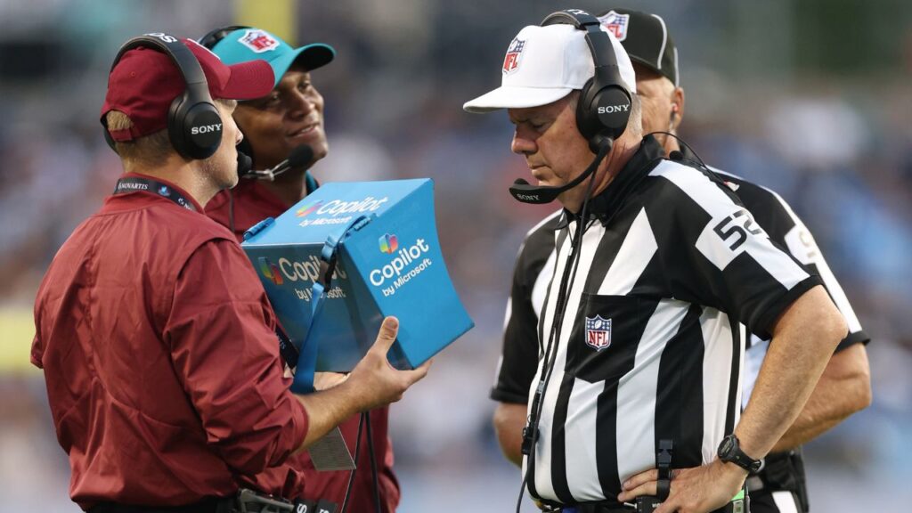 NFL referees watch a video replay review after a fumble in the first quarter between the Los Angeles Chargers and the Detroit Lions at Tom Benson Hall of Fame Stadium.