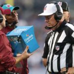 NFL referees watch a video replay review after a fumble in the first quarter between the Los Angeles Chargers and the Detroit Lions at Tom Benson Hall of Fame Stadium.