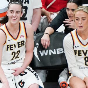 Indiana Fever guards Caitlin Clark (22)(L) and Sophie Cunningham (8) on the sidelines during the game against the Connecticut Sun