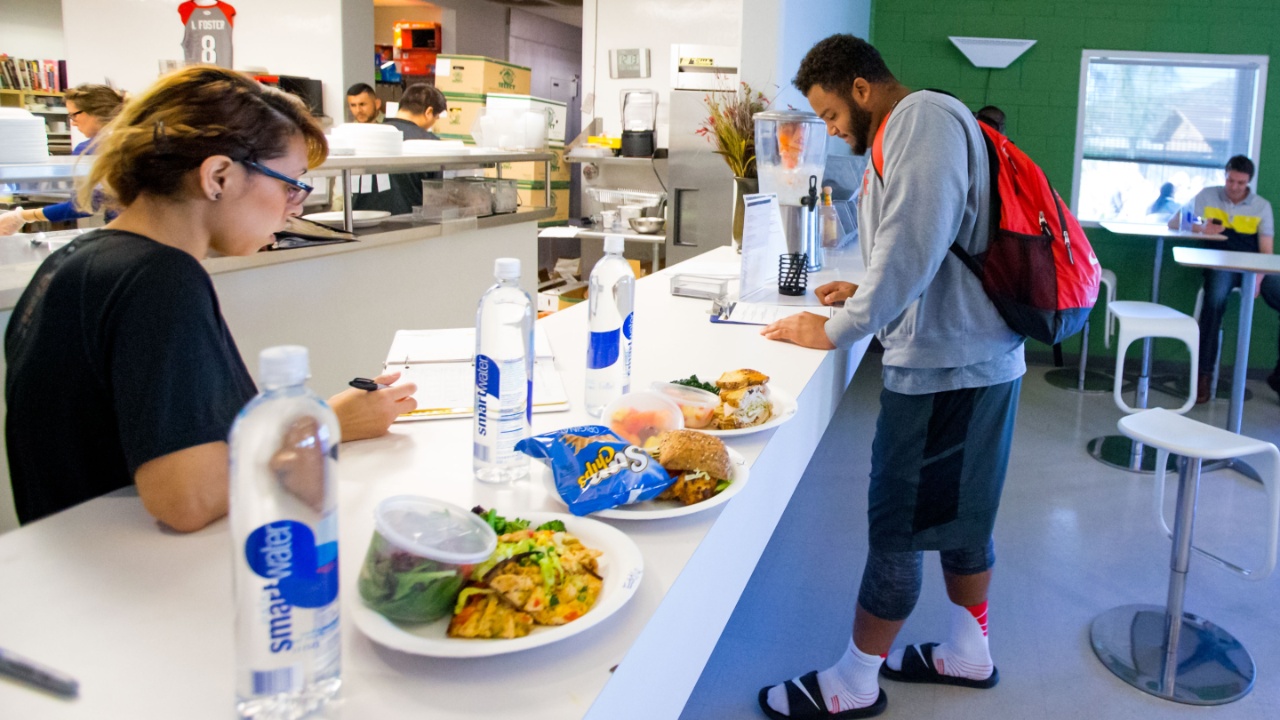 Ohio State Buckeyes defensive tackle Michael Bennett eats lunch in the cafeteria during training at EXOS gym in preparation for the NFL combine and draft.