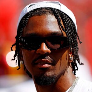 Washington Commanders quarterback Jayden Daniels (5) looks on from the sidelines during the game against the Baltimore Ravens at Northwest Stadium.