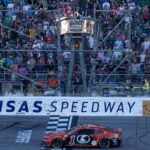 Sep 29, 2024; Kansas City, Kansas, USA; NASCAR Cup Series driver Ross Chastain (1) crosses the finish line to win the Hollywood Casino 400 at Kansas Speedway.