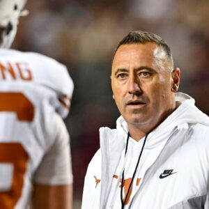 College Station, Texas, USA; Texas Longhorns head coach Steve Sarkisian speaks with quarterback Arch Manning (16) during warm ups against the Texas A&M Aggies at Kyle Field.