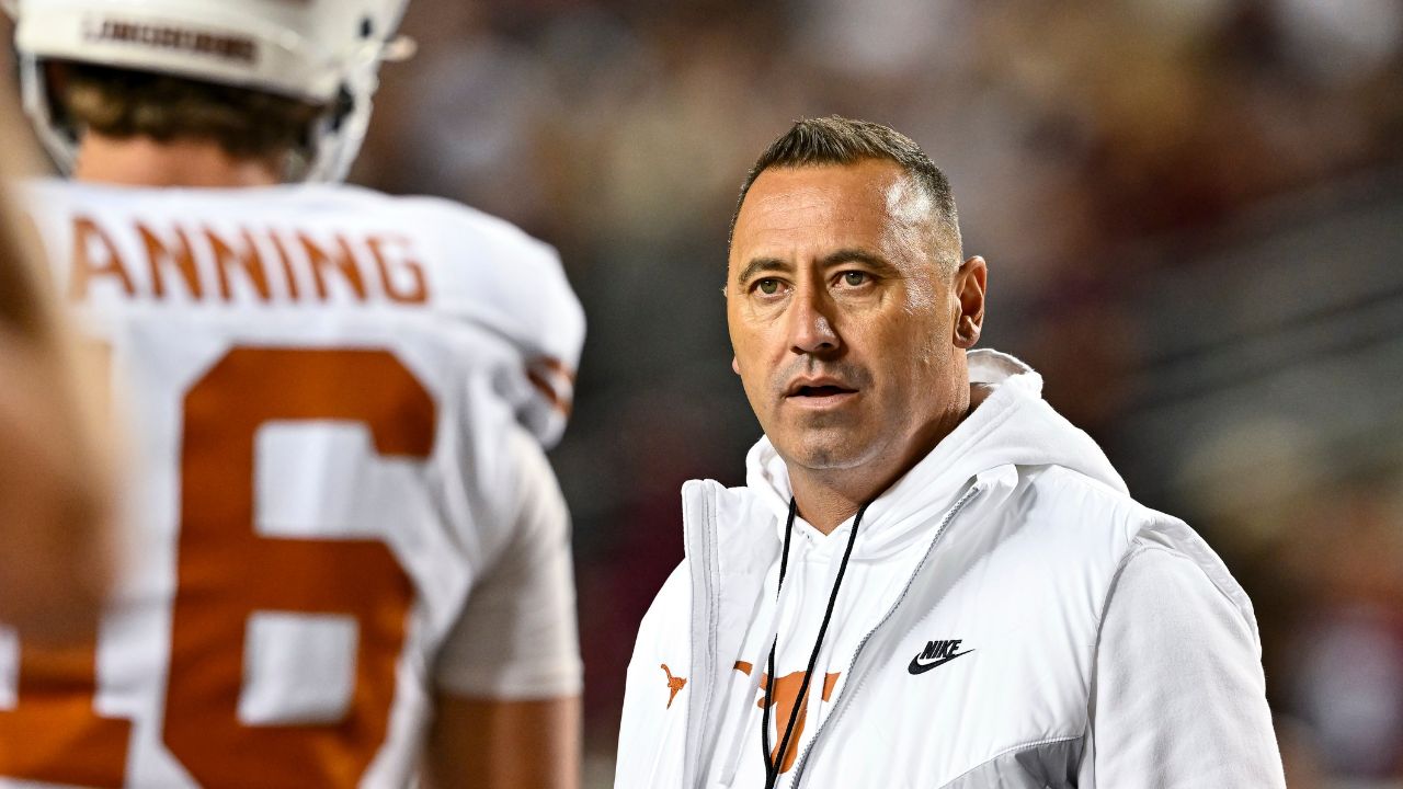 College Station, Texas, USA; Texas Longhorns head coach Steve Sarkisian speaks with quarterback Arch Manning (16) during warm ups against the Texas A&M Aggies at Kyle Field.