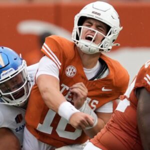 Texas Longhorns quarterback Arch Manning (16) reacts after getting hit by San Jose State Spartans linebacker Taniela Latu (4) during the second half at Darrell K Royal-Texas Memorial Stadium.