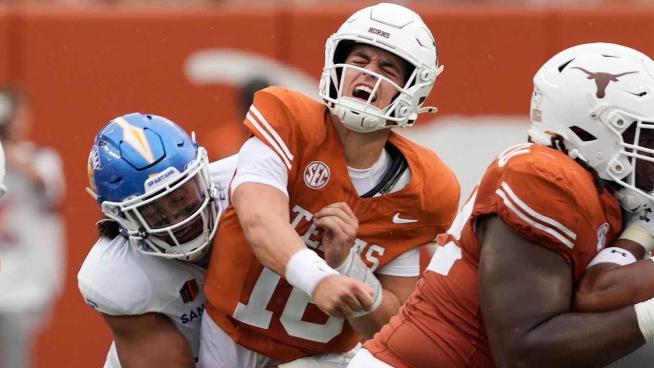 Texas Longhorns quarterback Arch Manning (16) reacts after getting hit by San Jose State Spartans linebacker Taniela Latu (4) during the second half at Darrell K Royal-Texas Memorial Stadium.