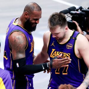 Los Angeles Lakers forward LeBron James (23) celebrates with Los Angeles Lakers guard Luka Doncic (77) during the fourth quarter against the Dallas Mavericks at American Airlines Center.