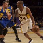 Los Angeles Lakers forward Kobe Bryant (24) drives into Golden State Warriors guard Stephen Curry (30) during the NBA