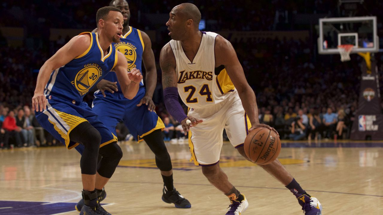 Los Angeles Lakers forward Kobe Bryant (24) drives into Golden State Warriors guard Stephen Curry (30) during the NBA