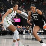 Las Vegas Aces center A'ja Wilson (22) drives past Minnesota Lynx forward Napheesa Collier (24) in the first quarter of their game at T-Mobile Arena.