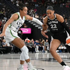 Las Vegas Aces center A'ja Wilson (22) drives past Minnesota Lynx forward Napheesa Collier (24) in the first quarter of their game at T-Mobile Arena.