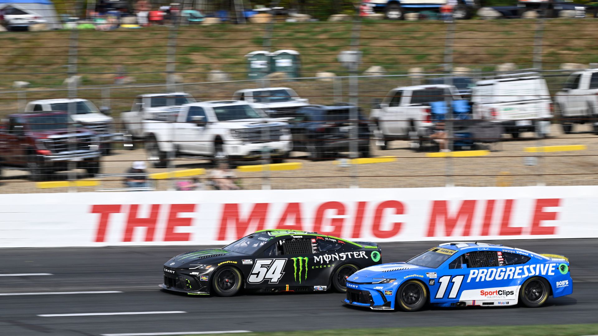 Sep 21, 2025; Loudon, New Hampshire, USA; NASCAR Cup Series driver Denny Hamlin (11) and NASCAR Cup Series driver Ty Gibbs (54) race during the Mobil 1 301 at New Hampshire Motor Speedway