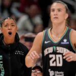 New York Liberty's Natasha Cloud (9) cheers on New York Liberty's Sabrina Ionescu (20) as she competes Friday, July 18, 2025, during the WNBA All-Star 3-point contest at Gainbridge Fieldhouse in Indianapolis.